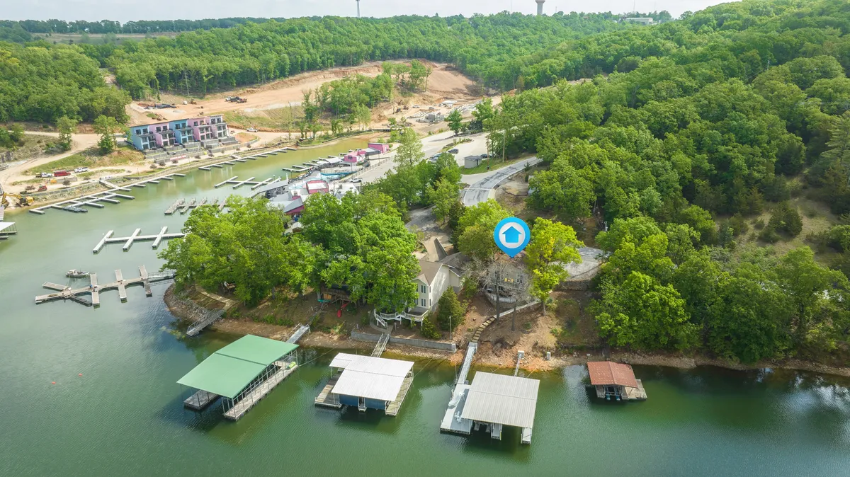 This image captures the lake with docks stretching out into the water, surrounded by a forested area. The scene feels calm and inviting, suggesting opportunities for walks, exploration, and relaxation for both pets and owners. The interplay of water and woods underlines the getaway's connection to outdoor adventure.